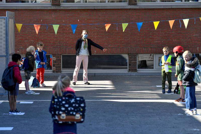 Pupils observe social distancing rules in the playground in Edegem, near Antwerp. AFP