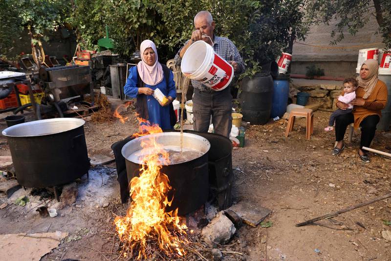 Palestinian Abed Al Lattif Karaje and his wife Nabeeha prepare traditional Malban sweets made from grape juice in  Halhul near Hebron city, in the occupied West Bank.