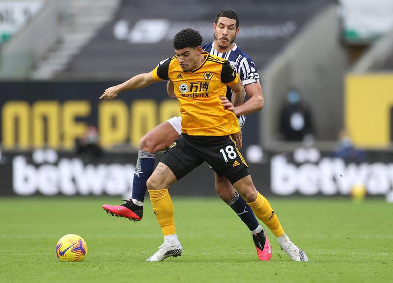 WOLVERHAMPTON, ENGLAND - JANUARY 16: Morgan Gibbs-White of Wolverhampton Wanderers is challenged by Jake Livermore of West Bromwich Albion during the Premier League match between Wolverhampton Wanderers and West Bromwich Albion at Molineux on January 16, 2021 in Wolverhampton, England. Sporting stadiums around England remain under strict restrictions due to the Coronavirus Pandemic as Government social distancing laws prohibit fans inside venues resulting in games being played behind closed doors. (Photo by Carl Recine - Pool/Getty Images)