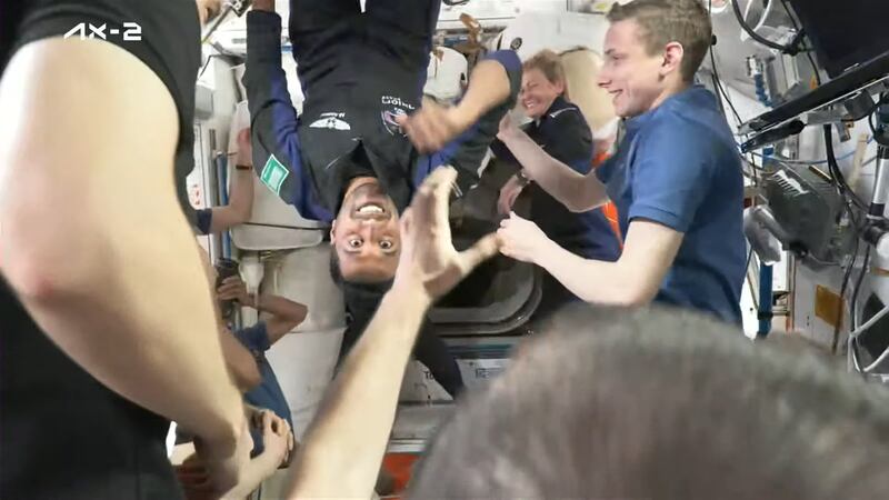 Saudi astronaut Mr Al Qarni floating upside down inside the ISS