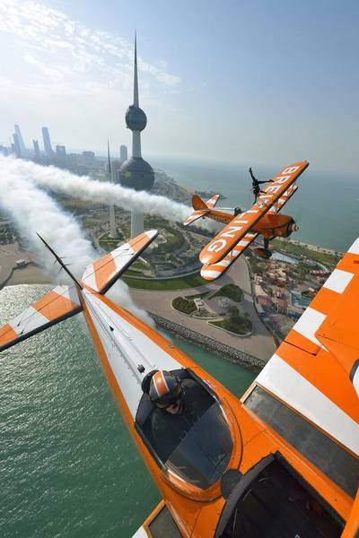 Breitling Wingwalker Freya Paterson, from Liverpool, UK, flies above Kuwait City’s iconic Water Towers with pilots David Barrell and Martyn Carrington. (Katsuhiko Tokunaga /Breitling via AP Images / March 6, 2014)