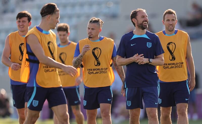 England manager Gareth Southgate enjoys a joke at training. EPA