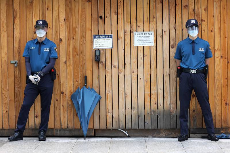 Police officers wear face shields and gloves as they stand guard at Gwanghwamun Plaza in Seoul, South Korea. EPA