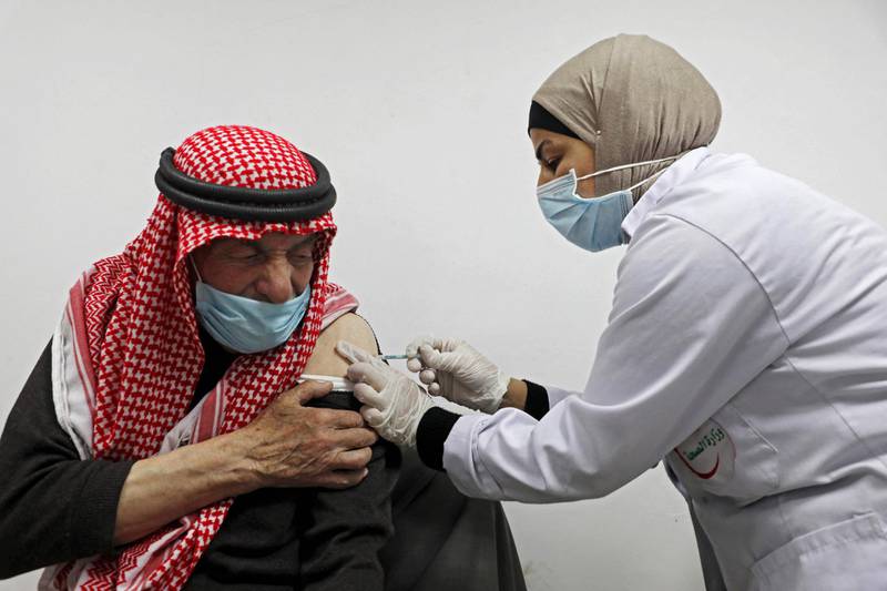 An elderly Palestinian man receives a shot of the Covid-19 coronavirus vaccine in the West Bank city of Nablus. AFP
