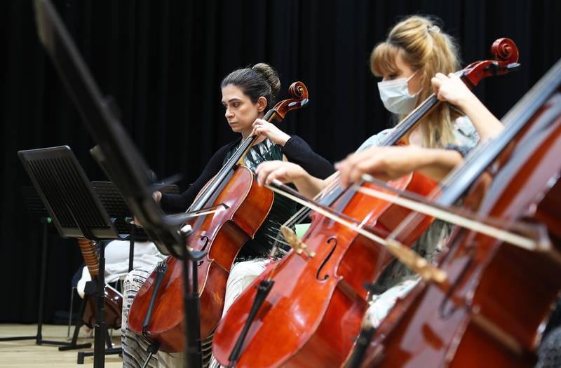 Elham Marzooqi (C) from UAE playing cello during the rehearsing of Firdaus Orchestra at the Gems Wellington school in Dubai.