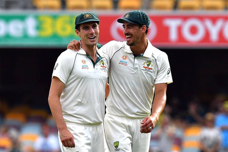 Australia's paceman Mitchell Starc (R) and Pat Cummins celebrate their victory in the first Test. AFP