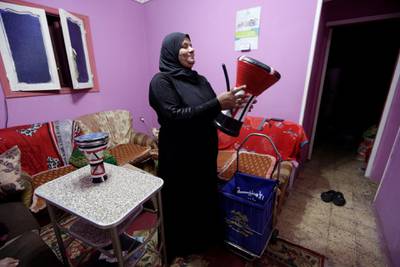 Hajja Dalal prepares her drum at home, before going out to wake up Muslims to have the predawn meal before they start their long-day fast during Ramadan, at Maadi neighbourhood in Cairo, Egypt. Reuters