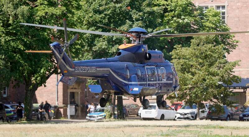 A German police helicopter lands at a courthouse after Thursday's arrests. EPA 