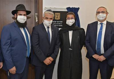 Left to right, Rabbi Levi Duchman, Israeli Foreign Minister Yair Lapid, Minister of Culture and Youth Noura Al Kaabi, and Israeli Foreign Ministry director general, Eitan Na'eh during the inauguration of the Israeli embassy in Abu Dhabi. AFP