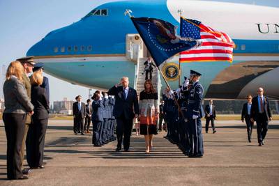 US president Donald Trump and first lady Melania Trump walk through an honour cordon as they arrive at Yokota Air Base at Fussa in Tokyo, Japan. Jim Watson / AFP Photo