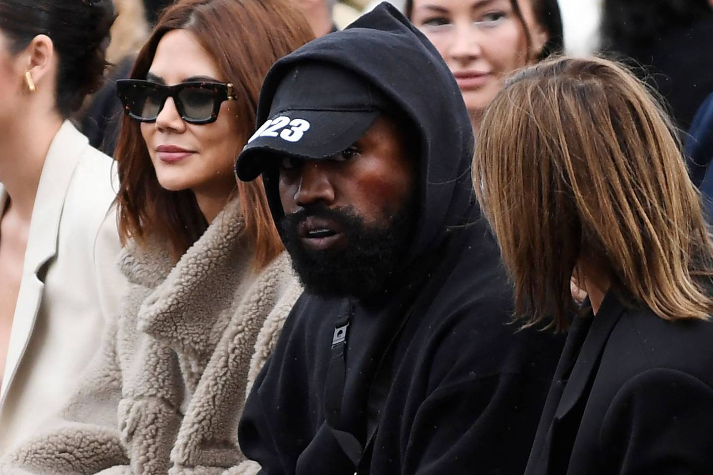 Kanye West, centre, attends the Givenchy spring/summer 2023 fashion show during Paris Fashion Week on October 2, 2022. AFP