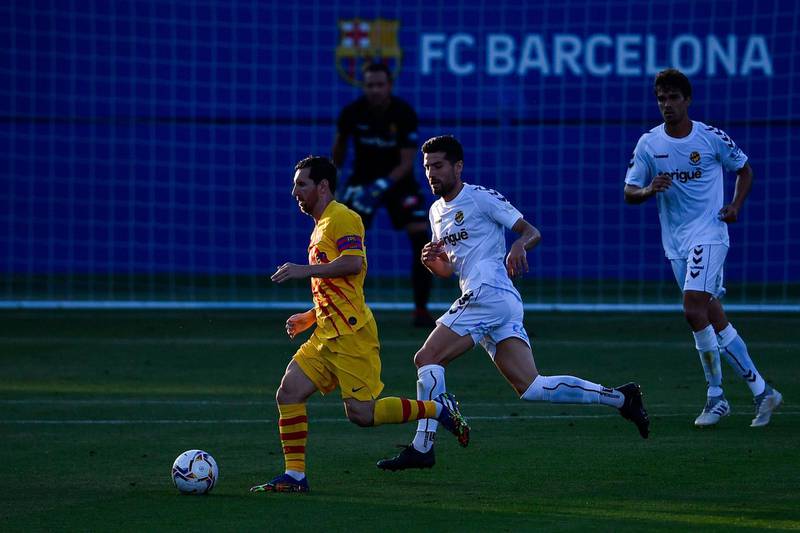 Lionel Messi runs with the ball during a friendly match between Barcelona and Gimnastic at the Johan Cruyff stadium. AFP