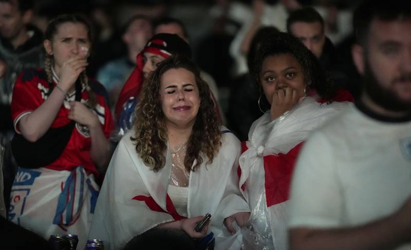 England supporters react in the fan zone at Trafalgar Square in London on  July 11, after Italy won the Euro 2020 soccer championship final match at Wembley Stadium.