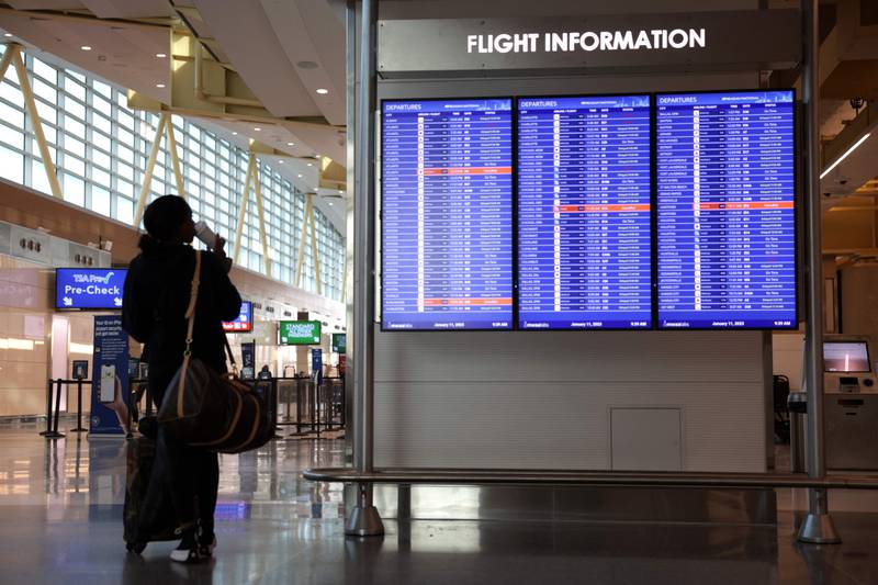 A traveller looks at a flight information board at Ronald Reagan Airport in Arlington, Virginia. AFP
