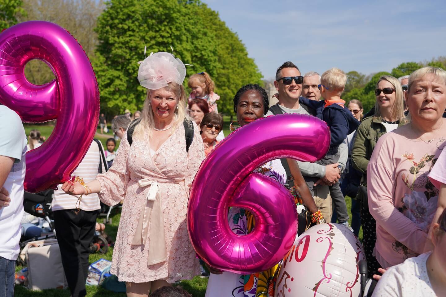 Royal fans Anne Daly, left, and Grace Gothard, right, hold balloons to celebrate the queen's 96th birthday at an event in Windsor. Victoria Pertusa / The National