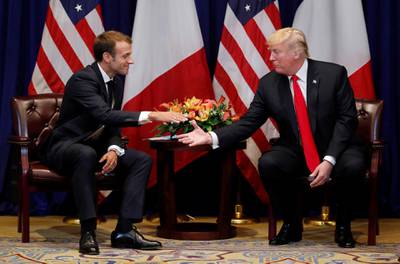 France's President Emmanuel Macron reaches out to shake hands as he holds bilateral meeting with US President Donald Trump. Reuters