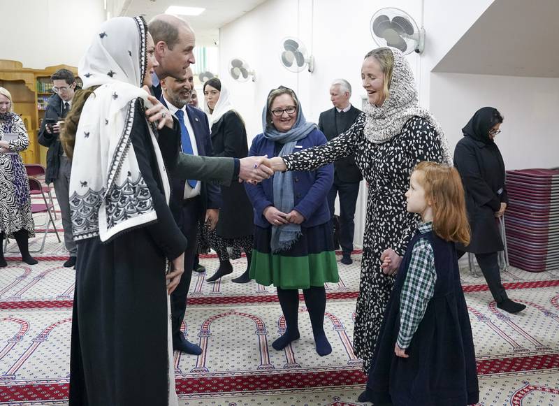 The Prince and Princess of Wales being greeted at the Hayes Muslim Centre. PA
