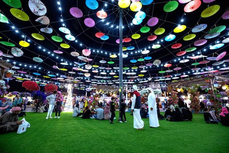 Visitors enjoy the evening at Sheikh Zayed Heritage Festival in Al Wathba, Abu Dhabi, on New Year's Eve. Victor Besa / The National