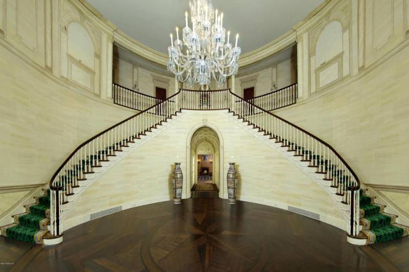 The grand foyer and double staircase were toned down by the property's new owners.
