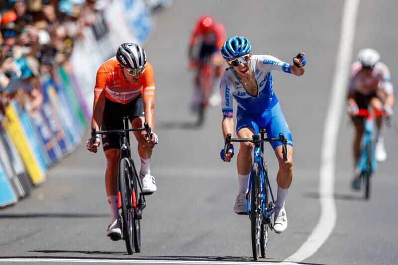 Simon Yates celebrates the stage victory as Jay Vine crosses to win the Tour Down Under. EPA