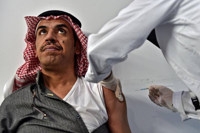A nurse administers a dose of vaccine against the covid-19 diseases at the Riyadh International Convention and Exhibition Center in the capital Riyadh, on January 21, 2021. Saudi Arabia launched its coronavirus vaccination campaign on December 17 after receiving the first shipment of the Pfizer-BioNTech vaccine.
The health ministry said the programme would roll out in three phases, starting with people over 65 and those with chronic ailments or at high risk of infection.
 / AFP / FAYEZ NURELDINE
