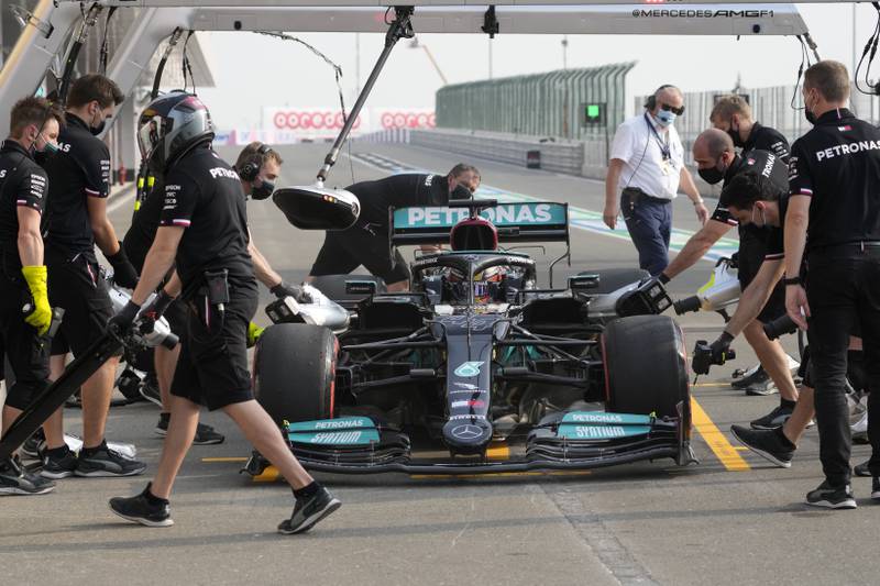 Mechanics work on Lewis Hamilton's car in Qatar. AP