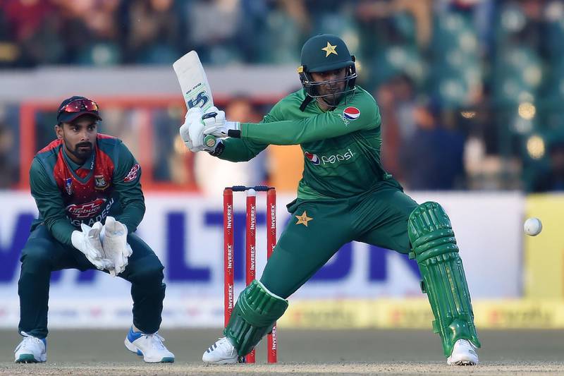 Pakistan's Shoaib Malik(R) plays a shot as Bangladesh's wicketkeeper Liton Das looks on during the first T20 international cricket match of a three-match series between Pakistan and Bangladesh at Gaddafi Cricket Stadium in Lahore on January 24, 2020.  / AFP / ARIF ALI
