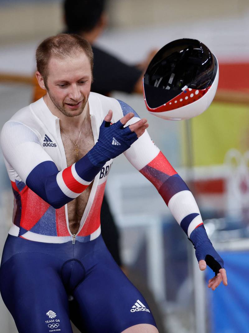 Britain's Jason Kenny tosses his helmet after taking gold.