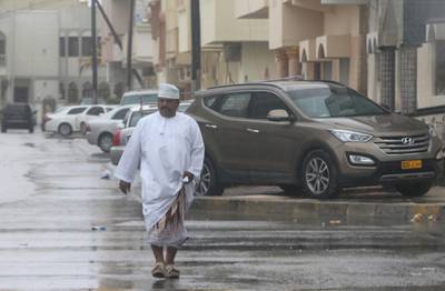 An Omani man walks down the street. Kamran Jebreili / AP Photo