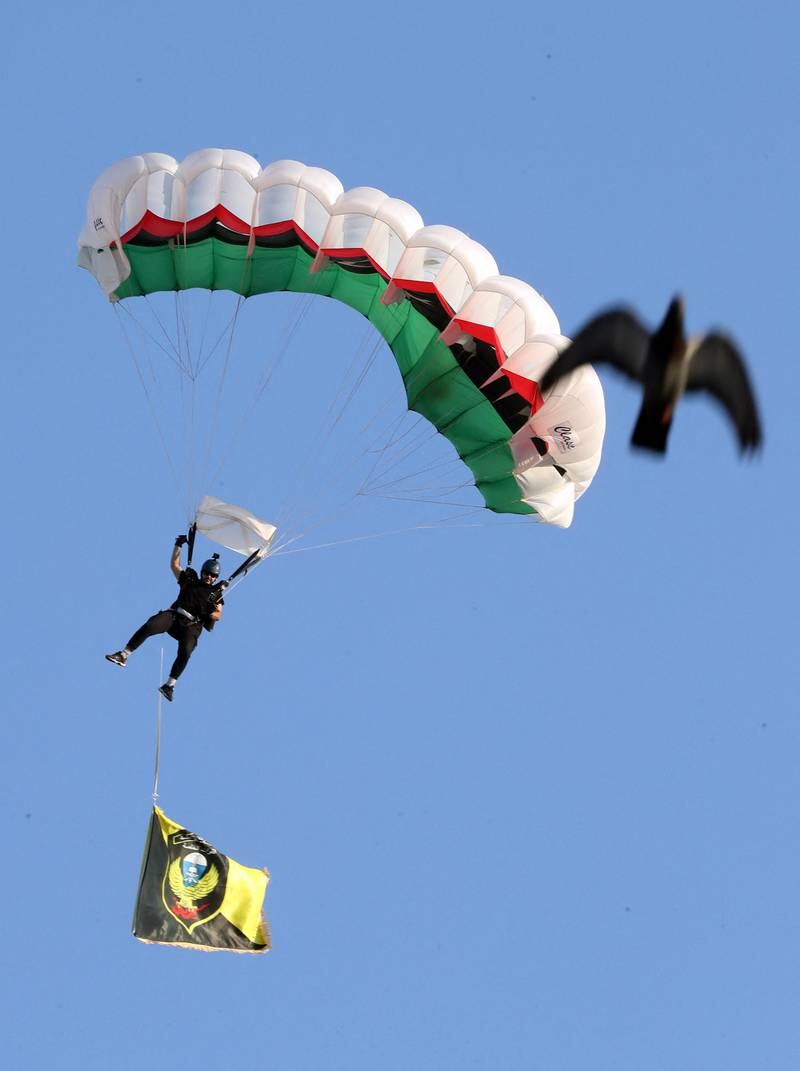 A parachutist lands during the parade to mark the army anniversary.
