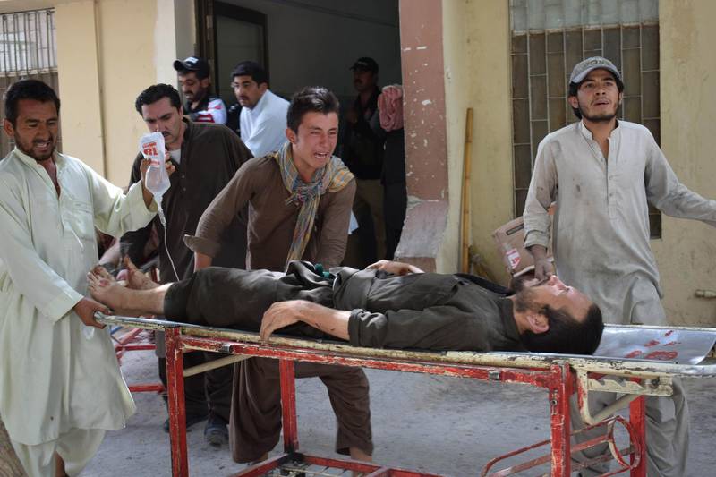A relative reacts as he carries an injured blast victim at a hospital after a suicide attack in Quetta. AFP