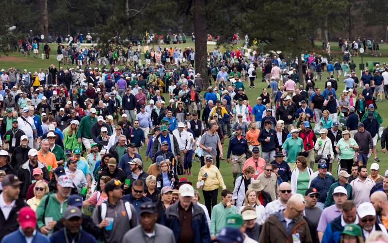 Fans leave the golf course during the weather delay. EPA
