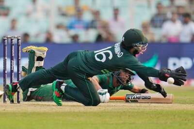 Bangladesh's Mahmudullah dives to make his ground as Pakistan's Mohammad Rizwan tries to run him out. AP