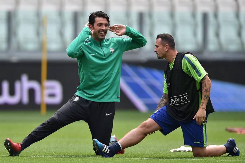 Gianluigi Buffon and Simone Pepe of Juventus stretch on Monday during their team training session for the Champions League final. Valerio Pennecino / Getty Images