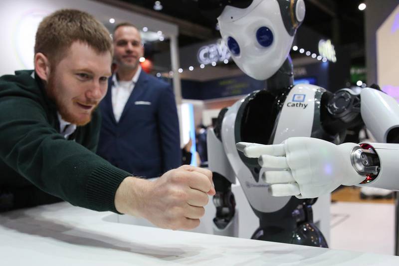 An attendee interacts with a humanoid robot called 'Cathy' on the CloudMinds Technology stand on day two of the MWC. Bloomberg