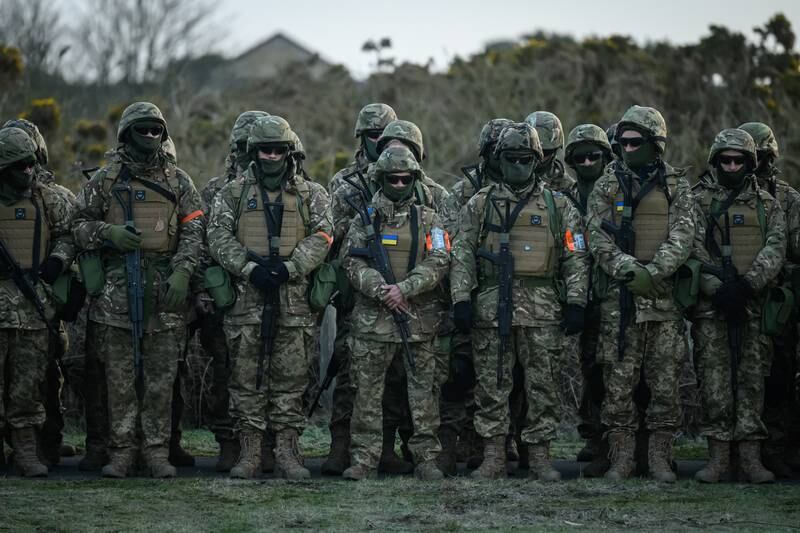 Ukrainian volunteers take part in prayers and observe a minute of silence, in south-east England. Getty
