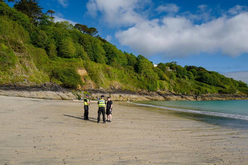 CARBIS BAY, CORNWALL - JUNE 03: Police officers patrol on the beach in front of the Carbis Bay Hotel, host venue for the G7 Summit conferences, on June 03, 2021 in Carbis Bay, Cornwall. On June 11, Prime Minister Boris Johnson will host the Group of Seven leaders at a three-day summit in Cornwall, as the wealthiest nations look to chart a course for recovery from the global pandemic.  (Photo by Hugh Hastings/Getty Images)