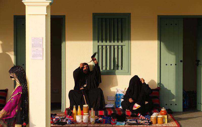 Emirati women spin wool.