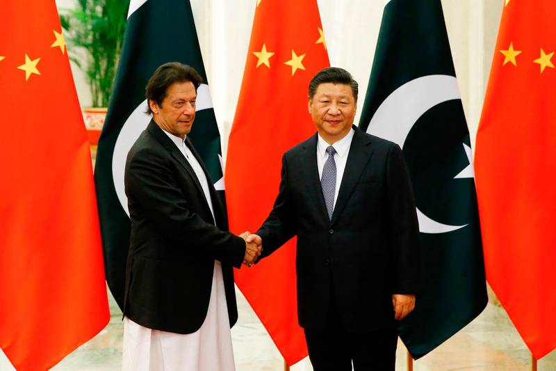 China's President Xi Jinping (R) shakes hands with Pakistan's Prime Minister Imran Khan (L) ahead of their meeting at the Great Hall of the People in Beijing.  AFP