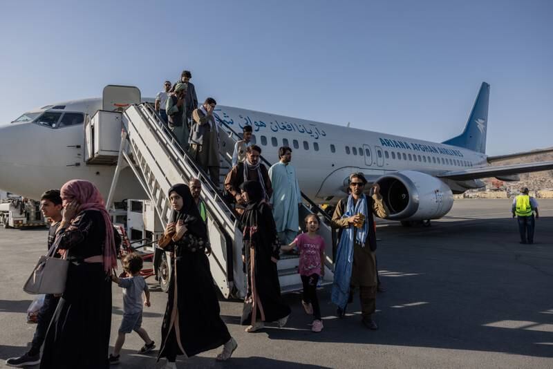 People disembark from the Ariana Afghan Airlines flight that landed in Kabul from Herat. Stefanie Glinski for The National