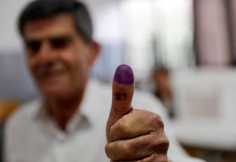 A Lebanese man showcases his ink-stained thumb after casting his vote in the first Lebanese parliamentary election in nine years, in the coastal city of Byblos, north of the capital Beirut. Joseph Eid / AFP