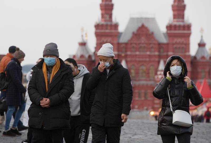 Tourists wear protective face masks as they walk in Red Square near the Kremlin in Moscow, Russia. 
 Bloomberg