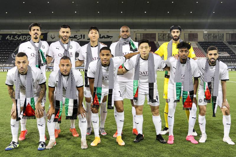Players of Qatar's Al Sadd SC football club, wearing Palestinian-style embroidered scarves in solidarity with the Palestinian people, pose for a group photo ahead of the Emir Cup semi-final match in Qatar's capital Doha. AFP