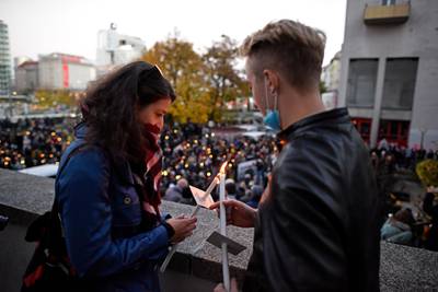 People light candles at the commemorative rally. Getty Images