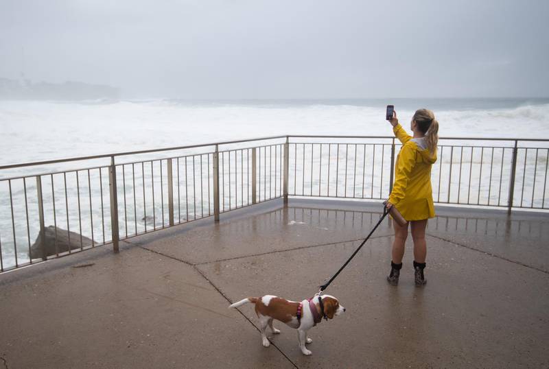 A person takes a photo of rough ocean conditions at Bronte Beach in Sydney. EPA