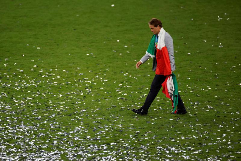 Roberto Mancini wears an Italian national flag around his neck after his team won the Uefa Euro final. AFP