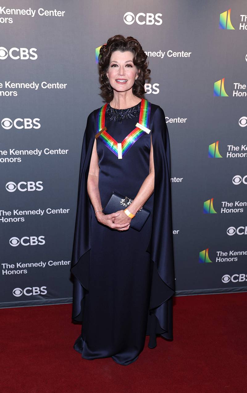 Honouree Amy Grant wearing a navy caped gown. Getty Images 