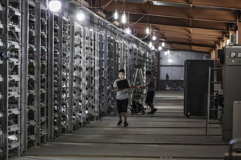 FILE: Technicians inspect bitcoin mining machines at a mining facility operated by Bitmain Technologies Ltd. in Ordos, Inner Mongolia, China, on Friday, Aug. 11, 2017. Bitcoin is showing no signs of slowing down, the price of the largest cryptocurrency by market value is soaring as it gains greater mainstream attention despite warnings of a bubble in what not everyone agrees is an asset. Our editors select the best archive images on Bitcoin. Photographer: Qilai Shen/Bloomberg