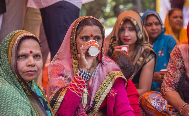 NEW DELHI, INDIA - MARCH 14: Women members and supporters of  'Akhil Bharat Hindu Mahasabha' (ABHM) a Hindu organisation, drink tea made with cow urine
during a 'gaumutra (cow urine) party' to fight against the spread of the COVID-19 coronavirus, by consumption of cow urine as a cure for the new coronavirus, organised by ABHM's president Chakrapani Maharaj  on March 14, 2020 in New Delhi, India. Many members of Prime Minister Narendra Modi's Bharatiya Janata Party have in the past claimed that cow urine and cow dung had medicinal properties and can cure deadly ailments like cancer. As the number of Covid-19 cases surge in various provinces of India continue to surge a lawmaker from Modi's right wing Hindu nationalist party told the legislative house in northeastern state of Assam that cow urine and cow dung could cure the deadly coronavirus which has led to over 5,000 deaths globally. (Photo by Yawar Nazir/Getty Images)