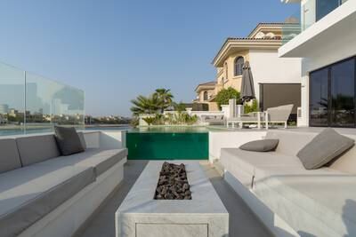 The garden overlooks the sea, while there are views into the side of the pool from the fire pit